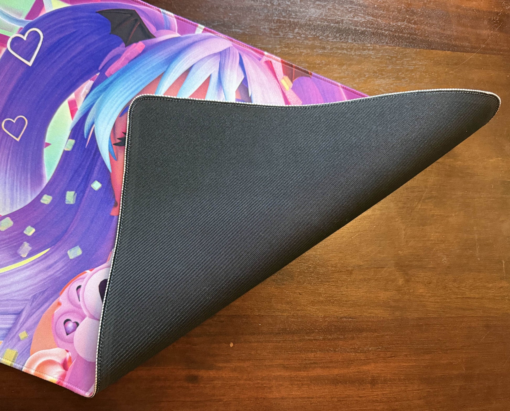 Bad Vibes colorful anime playmat with stitched edge and black non slip backing on wood table Magic the Gathering playmat