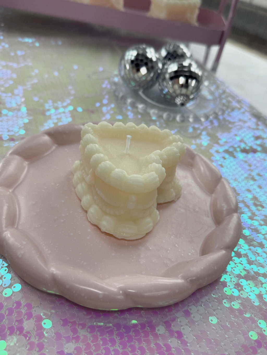 Bad Vibes vintage coquette cake candle ivory scalloped mini cake on pink braided plate with disco balls
