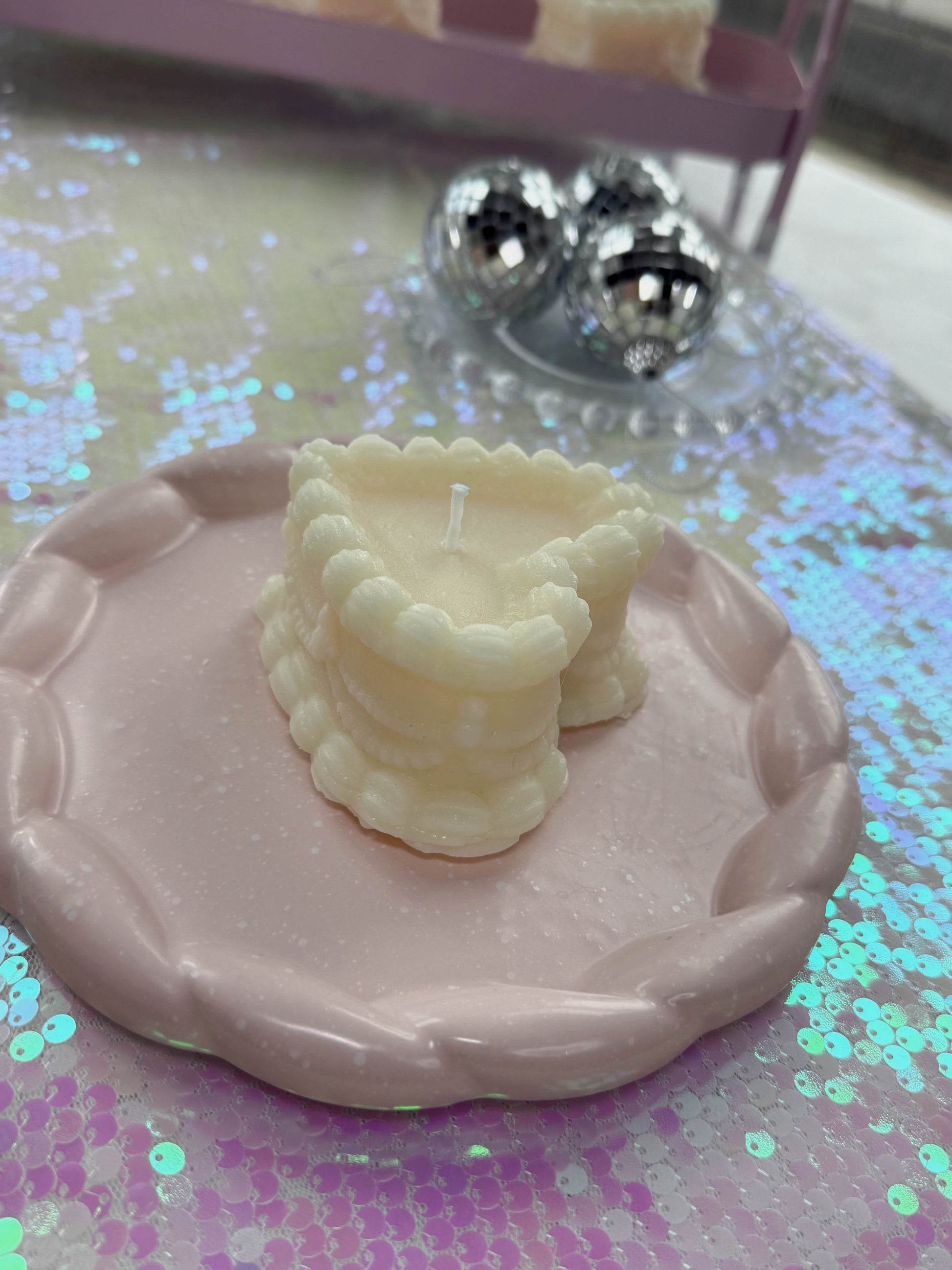 Bad Vibes vintage coquette cake candle ivory scalloped mini cake on pink braided plate with disco balls