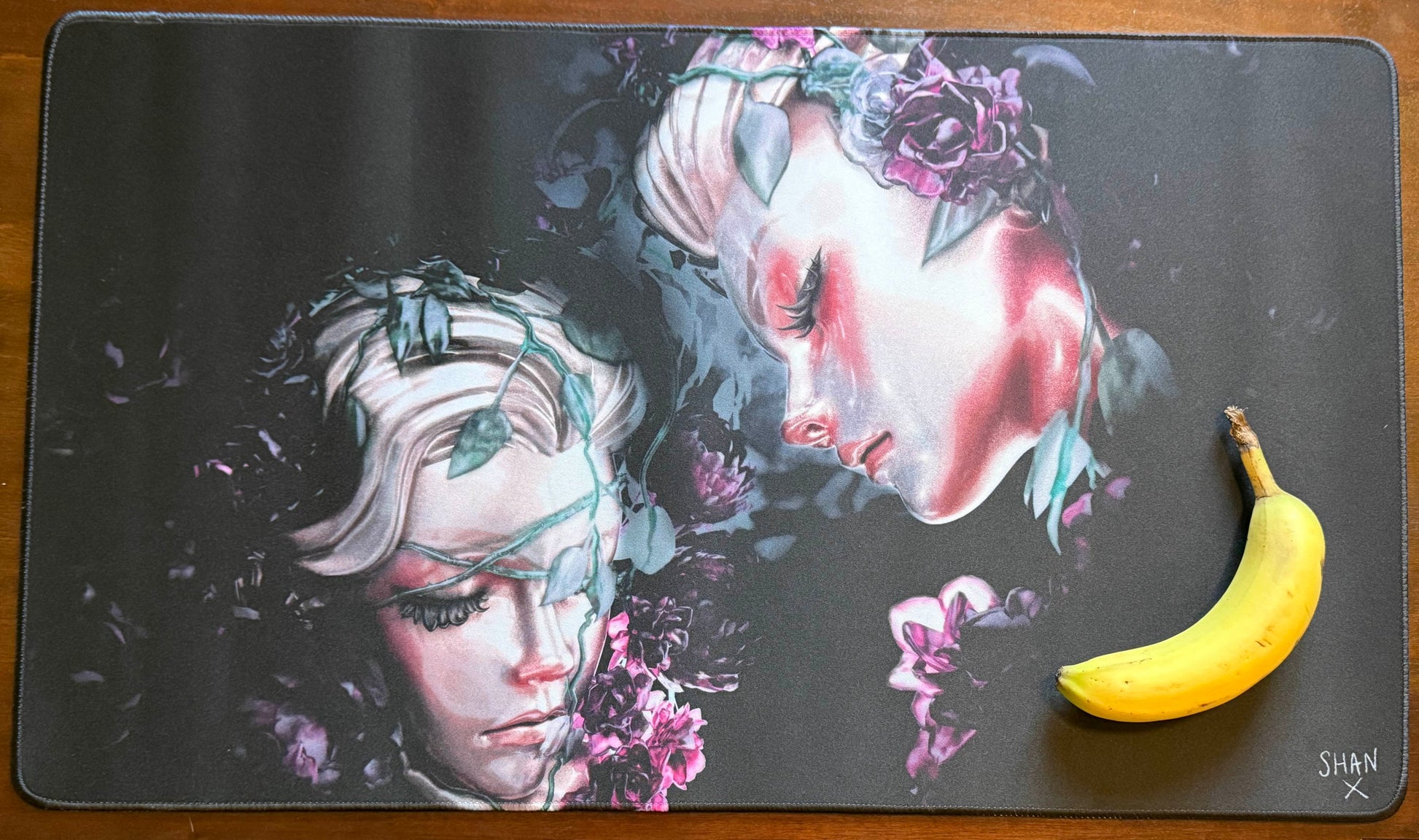 Bad Vibes home decor mat with dark surreal art of two floral faces on black background banana for scale